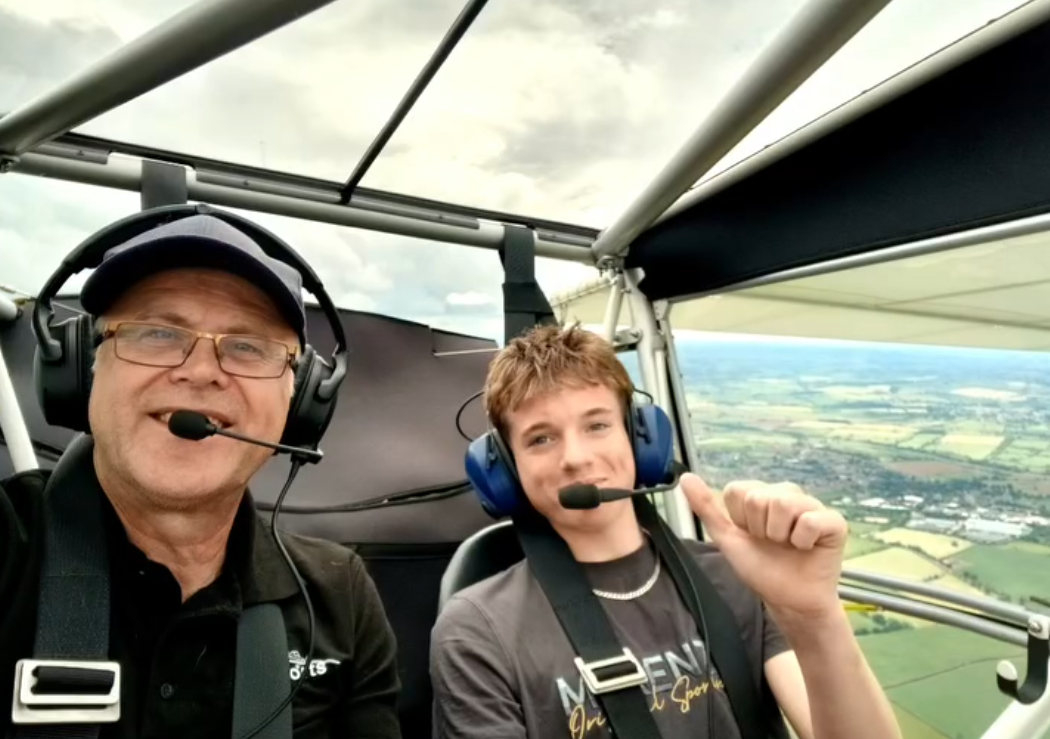 Instructor and student giving a thumbs up in the cockpit